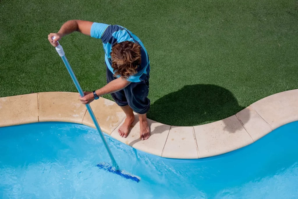 Man Cleaning Pool 