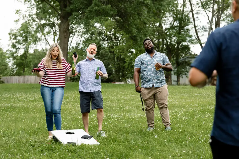 Friends Playing Cornhole Summer Party Park - Bemister'S Pool &Amp; Patio